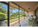 Relaxing screened patio with seating area and tranquil garden views at 6542 Draw Ln # 90, Sarasota, FL 34238
