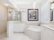 Elegant bathroom with a soaking tub, double vanity, and walk-in shower at 7131 Sandhills Pl, Lakewood Ranch, FL 34202