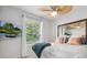 Cozy bedroom with a queen bed and a large window with a garden view at 7131 Sandhills Pl, Lakewood Ranch, FL 34202