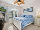Guest bedroom with a king-size bed and a view of the lush garden at 7131 Sandhills Pl, Lakewood Ranch, FL 34202