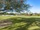 Scenic golf course view with homes in the background at 7131 Sandhills Pl, Lakewood Ranch, FL 34202
