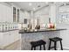 Modern kitchen featuring white cabinets, granite countertops, and a breakfast bar at 7131 Sandhills Pl, Lakewood Ranch, FL 34202