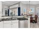 Modern kitchen with white cabinets, granite countertops, and stainless steel appliances at 7131 Sandhills Pl, Lakewood Ranch, FL 34202