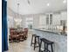 Bright kitchen with white cabinets, granite counters, and breakfast bar at 7131 Sandhills Pl, Lakewood Ranch, FL 34202