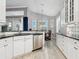 Modern kitchen with white cabinets, granite countertops, and stainless steel appliances at 7131 Sandhills Pl, Lakewood Ranch, FL 34202