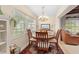 Dining room features a wood table, chandelier, and window seat at 7705 Alhambra Dr, Bradenton, FL 34209