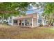 Front view of a single-story house with a covered porch and lush landscaping at 7705 Alhambra Dr, Bradenton, FL 34209