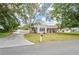 Single-story home with a terracotta roof, driveway, and mature landscaping at 7705 Alhambra Dr, Bradenton, FL 34209