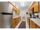 Kitchen with wood cabinets, stainless steel appliances, and tiled backsplash at 7705 Alhambra Dr, Bradenton, FL 34209