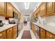 Kitchen with wood cabinets, stainless steel appliances, and a view to the dining area at 7705 Alhambra Dr, Bradenton, FL 34209