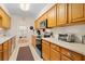 Kitchen boasts wood cabinets, stainless steel appliances, and tiled backsplash at 7705 Alhambra Dr, Bradenton, FL 34209