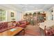 Cozy library featuring built-in bookshelves, leather armchairs, and a warm inviting atmosphere at 7705 Alhambra Dr, Bradenton, FL 34209