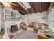 Living room features a fireplace, leather sofas, and a view into the dining area at 7705 Alhambra Dr, Bradenton, FL 34209