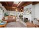 Living room with fireplace, leather furniture, and large windows at 7705 Alhambra Dr, Bradenton, FL 34209