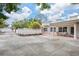 Large side yard with concrete paving and white fence at 7705 Alhambra Dr, Bradenton, FL 34209