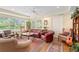 Sunroom with leather furniture, harp, and ample natural light at 7705 Alhambra Dr, Bradenton, FL 34209