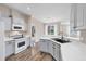 Bright kitchen with gray cabinets, white countertops, and stainless steel appliances at 8206 Haven Harbour Way, Bradenton, FL 34212