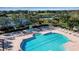 Resort-style pool with surrounding lounge chairs and a playground in the background at 9203 Winter Harbour Way, Bradenton, FL 34212