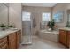 Bathroom with soaking tub, walk-in shower, and double vanity at 9203 Winter Harbour Way, Bradenton, FL 34212