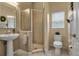 Bathroom with a shower, pedestal sink, and tile flooring at 9203 Winter Harbour Way, Bradenton, FL 34212