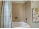Clean bathroom with shower, pedestal sink, and tile flooring at 9203 Winter Harbour Way, Bradenton, FL 34212
