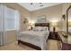 Guest bedroom with a queen bed and dark wood furniture at 9203 Winter Harbour Way, Bradenton, FL 34212