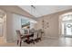 Bright dining room features a large wooden table with seating for six and a modern chandelier at 9203 Winter Harbour Way, Bradenton, FL 34212