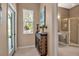Bright entryway with a wooden cabinet and access to a bathroom at 9203 Winter Harbour Way, Bradenton, FL 34212