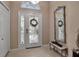 Elegant entryway with white door, etched glass, and console table at 9203 Winter Harbour Way, Bradenton, FL 34212