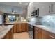 Modern kitchen with stainless steel appliances and granite countertops at 9203 Winter Harbour Way, Bradenton, FL 34212