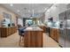 Open concept kitchen with island and breakfast bar at 9203 Winter Harbour Way, Bradenton, FL 34212