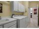 Bright laundry room with washer, dryer, and cabinets at 9203 Winter Harbour Way, Bradenton, FL 34212