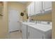 Bright laundry room with washer, dryer, and cabinets at 9203 Winter Harbour Way, Bradenton, FL 34212