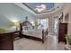 Main bedroom with king-size bed, ceiling fan, and access to private bathroom at 9203 Winter Harbour Way, Bradenton, FL 34212