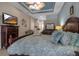 Main bedroom with king bed, dresser, and large TV at 9203 Winter Harbour Way, Bradenton, FL 34212
