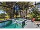 Relaxing screened pool and spa with surrounding greenery at 9203 Winter Harbour Way, Bradenton, FL 34212