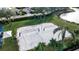 Sand volleyball court with surrounding landscaping and lake view at 9203 Winter Harbour Way, Bradenton, FL 34212