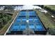 Aerial view of well-lit tennis and pickleball courts at 9203 Winter Harbour Way, Bradenton, FL 34212