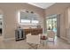 Modern wet bar with wine cooler, cabinetry, and seating area at 9203 Winter Harbour Way, Bradenton, FL 34212