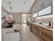Modern wet bar with wine cooler and kitchen view at 9203 Winter Harbour Way, Bradenton, FL 34212