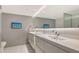 Modern bathroom with double vanity and floating sinks at 988 Blvd Of The Arts # 311, Sarasota, FL 34236
