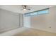 Simple bedroom with ceiling fan and window at 988 Blvd Of The Arts # 311, Sarasota, FL 34236