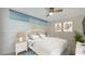 Bedroom with a queen bed and coastal decor at 988 Blvd Of The Arts # 311, Sarasota, FL 34236