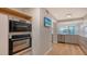 Modern kitchen with double oven and stainless steel appliances at 988 Blvd Of The Arts # 311, Sarasota, FL 34236