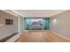 Bright living room with hardwood floors and sliding glass doors leading to a balcony with water views at 988 Blvd Of The Arts # 311, Sarasota, FL 34236