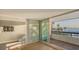 Living room with hardwood floors, water views and access to balcony at 988 Blvd Of The Arts # 311, Sarasota, FL 34236