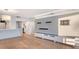 Living room with hardwood floors and modern built-in shelving at 988 Blvd Of The Arts # 311, Sarasota, FL 34236