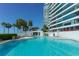 Inviting swimming pool with surrounding lounge chairs at 988 Blvd Of The Arts # 311, Sarasota, FL 34236