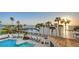 Community pool with waterfront views and lounge chairs at 988 Blvd Of The Arts # 311, Sarasota, FL 34236