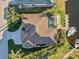 Aerial view of home, pool, boat dock, and lush landscaping along canal in a desirable neighborhood at 1111 Socorro Dr, Punta Gorda, FL 33950